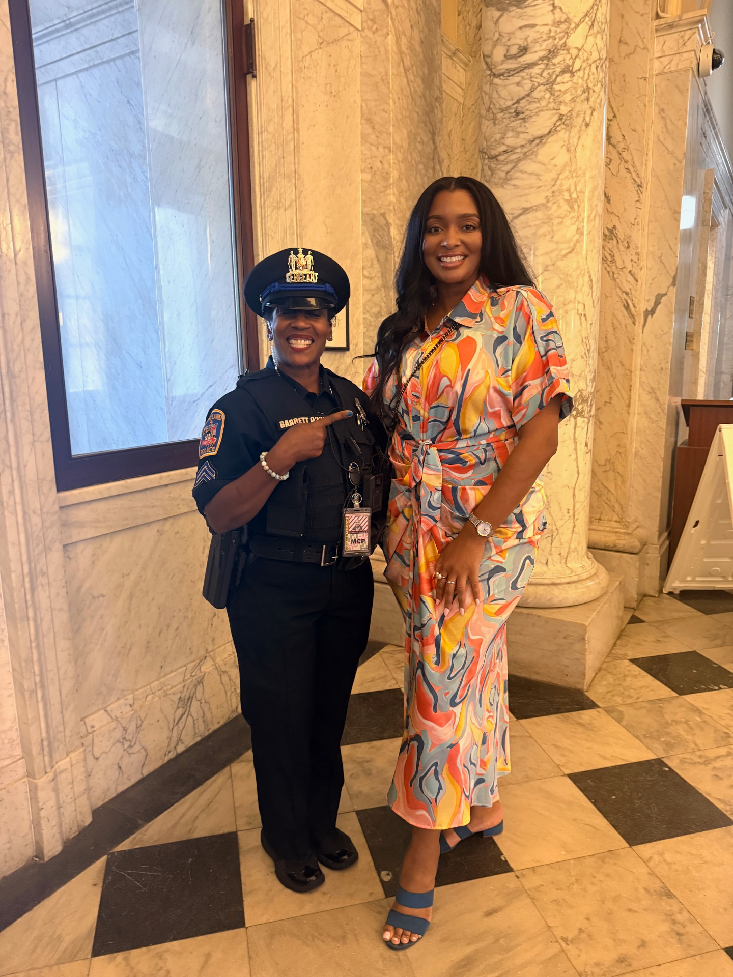 Yvonne Harper with a Maryland police sergeant at the State House